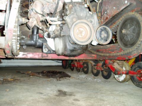 2000 Ford E350 - Underside view of a vehicle's engine and track system, showing mechanical components and multiple wheels.