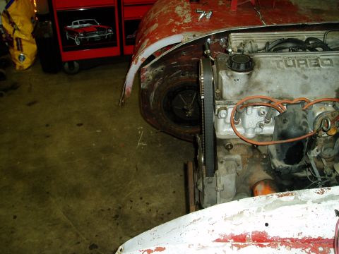 2000 Ford E350 - Close-up view of an engine compartment and wheel well, suggesting ongoing automotive work.