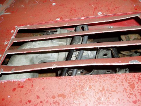 2000 Ford E350 - Engine component visible through a slatted red panel.