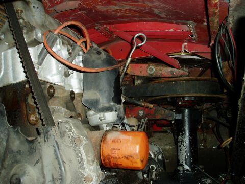2000 Ford E350 - Close-up view of engine components, including an oil filter and belts.