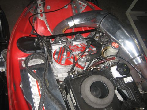 1995 Ford Bronco - Close-up view of a red snowmobile engine, showing the chrome exhaust and drive belt.