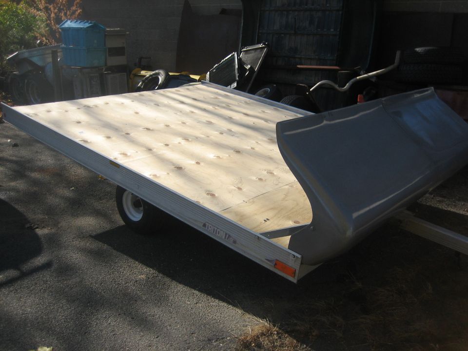 Trailer with wooden deck and gray cover