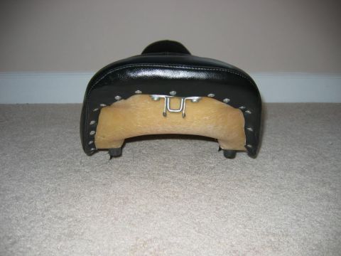 1985 Ford LTD Crown Victoria - Black motorcycle seat with exposed foam and metal mounting hardware.