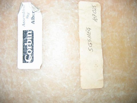 1985 Ford LTD Crown Victoria - Two labels are visible on a textured surface, one with brand and assembly information, the other with alphanumeric codes.