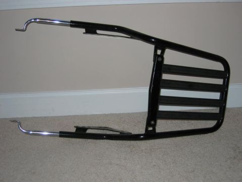 1985 Ford LTD Crown Victoria - This is a black motorcycle luggage rack with chrome mounting points.