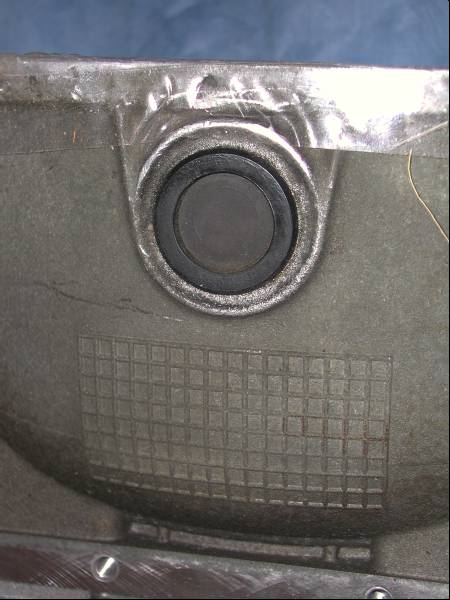 2001 Ford F-150 - This is the torque converter drain dust cover, pops out by hand. Up is to the front of the vehicle.