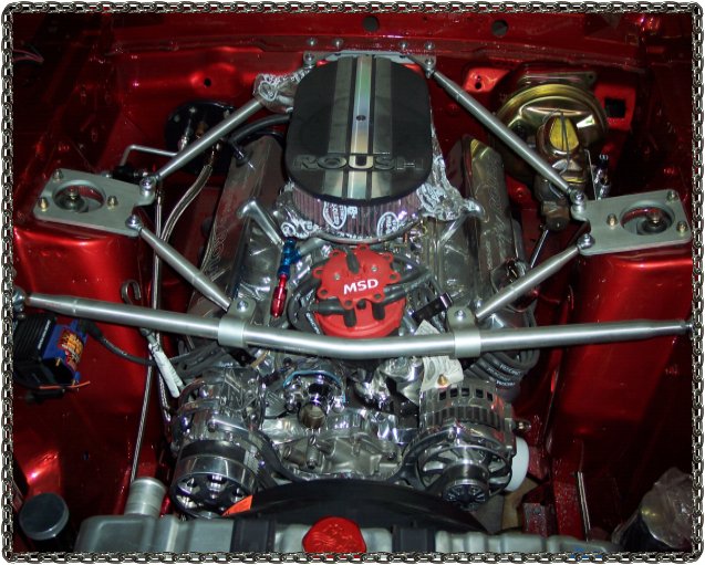 Engine bay with a V8 engine, MSD ignition, and Roush air cleaner. Chrome and polished aluminum parts are visible