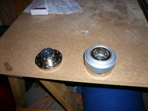 1996 Ford Probe - Two mechanical components are laid out on a workbench, possibly for repair or inspection.