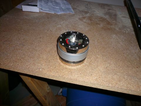 1996 Ford Probe - A steering wheel hub adapter is shown on a workbench, with some paperwork in the background.