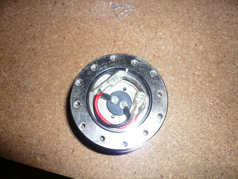 1996 Ford Probe - Close-up view of a steering wheel hub adapter, showing internal wiring and mounting holes.