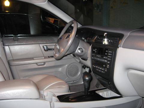 2002 Ford Taurus - The interior of a 2002 Ford Taurus is shown, the driver's side door, dashboard, and center console.