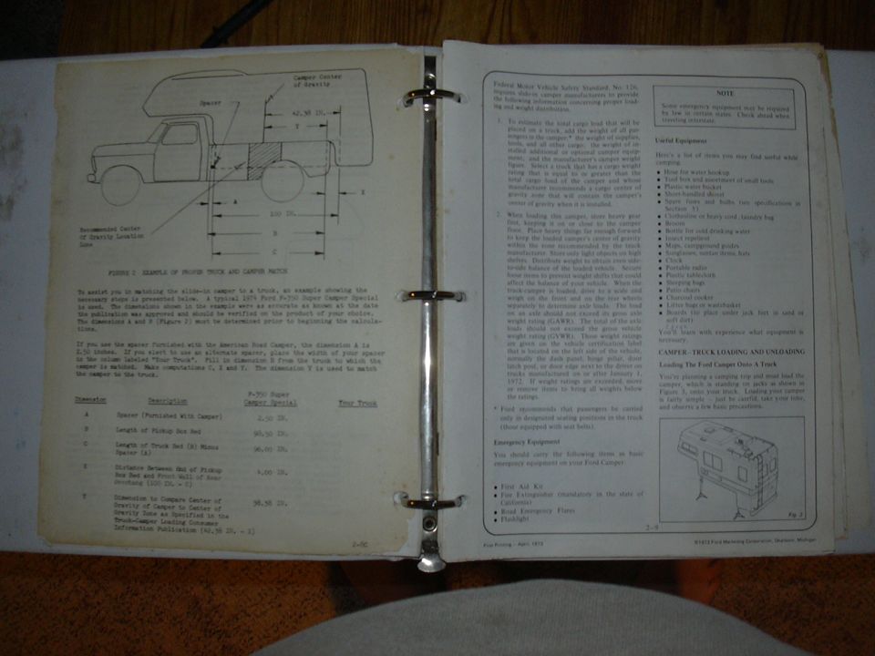 Ford camper loading guide in a binder with a truck and camper center of gravity diagram and dimension table