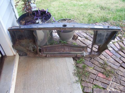 1965 Pontiac Bonneville - This rusty radiator support frame is a replacement part for a vintage vehicle.