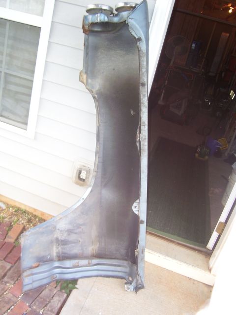 1965 Pontiac Bonneville - A detached car fender is shown from the inside, with visible rust and damage.