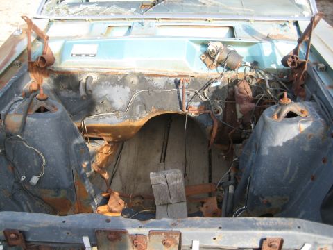 1967 Mercury Cyclone - The engine bay is heavily rusted and appears to be from a derelict vehicle.