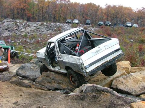 1995 Ford Bronco - Modified Ford Bronco navigates a rocky obstacle course during an off-road event.