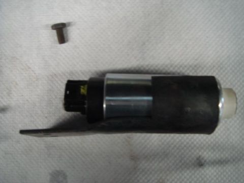 1996 Ford Bronco - A cylindrical electric fuel pump with a black plastic top, chrome metal body, mounting bracket, and white outlet nozzle, shown alongside a…