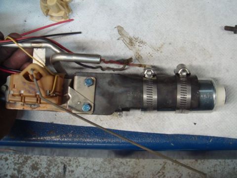 1996 Ford Bronco - A modified in-tank fuel pump assembly with a plastic sending unit/float bracket, metal fuel line, and a fuel pump held by hose clamps to a…