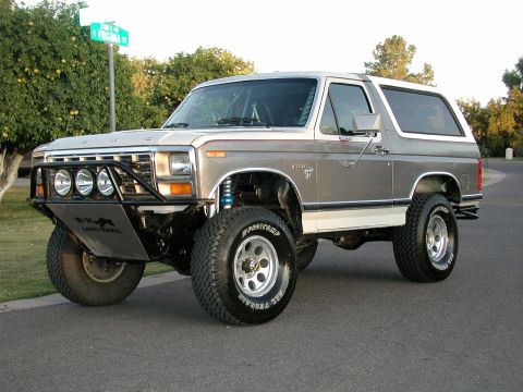 1980 Ford Bronco - This modified Ford Bronco features a custom front bumper and suspension lift, giving it an aggressive stance.