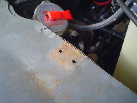 1984 Ford Bronco - Close-up view of a radiator cap and surrounding engine bay components, showing signs of wear and rust.