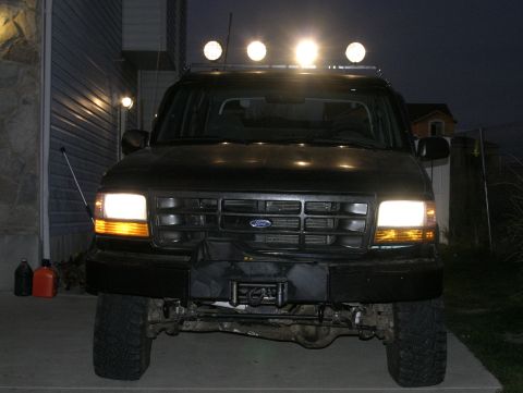 1994 Ford Bronco - Front view of a black 1994 Ford Bronco, equipped with roof-mounted lights and a tow hitch.