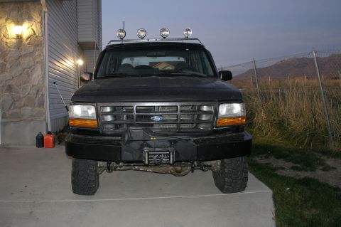 1994 Ford Bronco - Front view of a black Ford Bronco with off-road modifications.