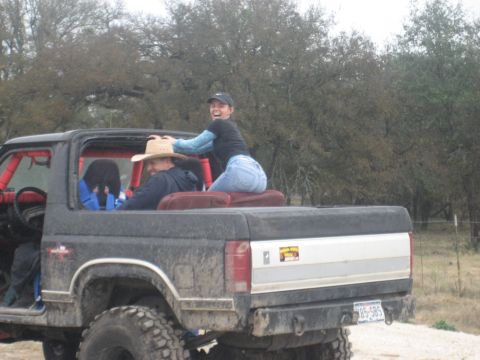 2001 Jeep Wrangler - People ride in a lifted pickup truck, enjoying an outdoor excursion.