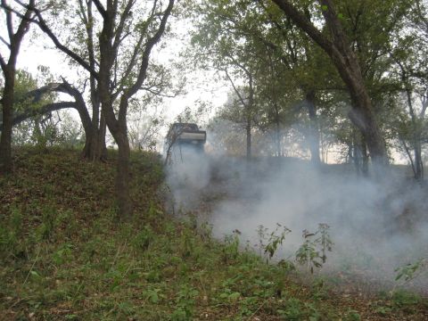 2001 Jeep Wrangler - A Jeep Wrangler is seen driving through smoke on a wooded incline.