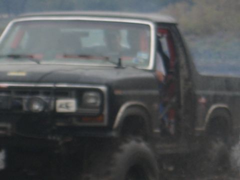 2001 Jeep Wrangler - This black Ford Bronco II features a visible roll cage and appears to be off-roading.