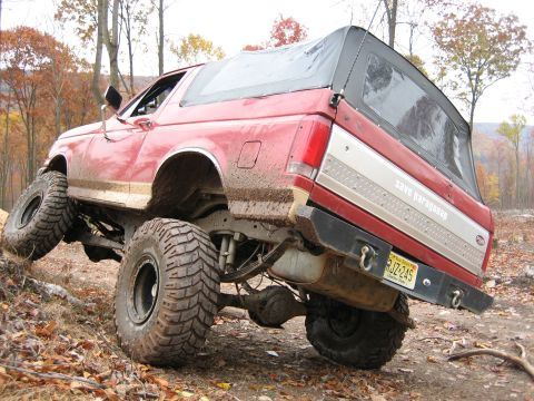 1990 Ford Bronco - This lifted 1990 Ford Bronco navigates a challenging off-road trail.