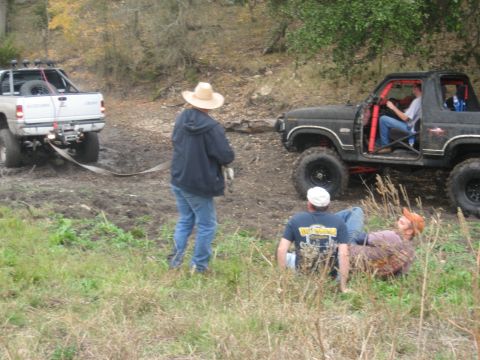 2001 Jeep Wrangler - Two off-road vehicles are engaged in an activity, with people observing the situation.