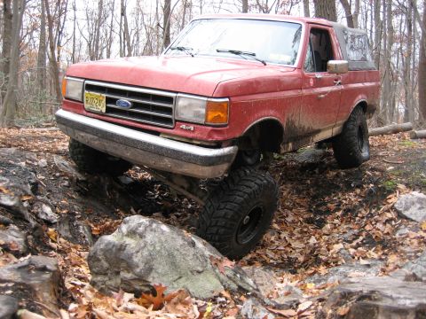1990 Ford Bronco - This 1990 Ford Bronco tackles a challenging off-road course with large tires and a lifted suspension.
