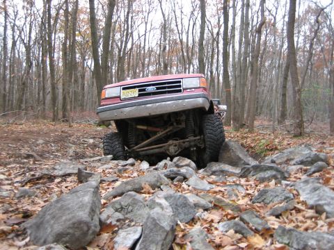 1990 Ford Bronco - Red 1990 Ford Bronco tackling a challenging rock crawl course.