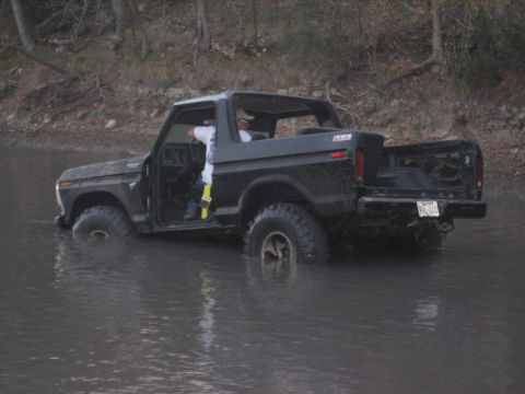 2001 Jeep Wrangler - This black Ford F-Series pickup truck appears to be stuck in a body of water.