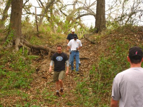 2001 Jeep Wrangler - Four men descend a wooded slope covered in fallen leaves.