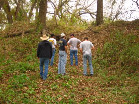 2001 Jeep Wrangler - Five men walk up a leaf-strewn path through a wooded area with trees and brush.