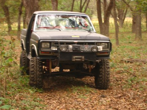 2001 Jeep Wrangler - This lifted pickup truck, likely from the early 1980s, is equipped for off-road use with large tires and a winch.
