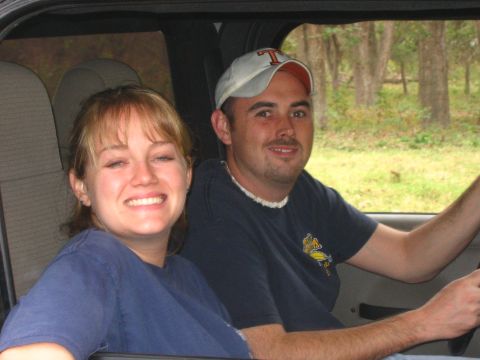 2001 Jeep Wrangler - A couple is inside a vehicle, with trees visible through the windows.