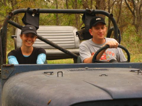 2001 Jeep Wrangler - A man and woman sit in a blue Jeep Wrangler, ready for an outdoor adventure.