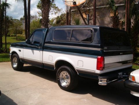1995 Ford F-150 - This 1995 Ford F-150 pickup features a two-tone paint scheme and a camper shell.