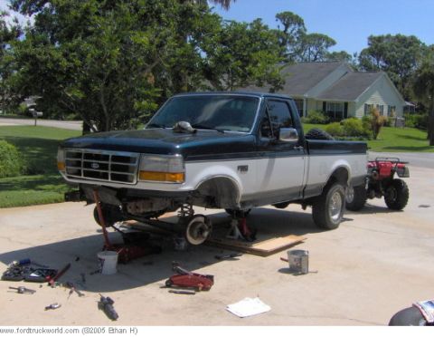 1995 Ford F-150 - A 1995 Ford F-150 pickup truck is shown with its front end raised on jack stands, indicating maintenance or modification work.