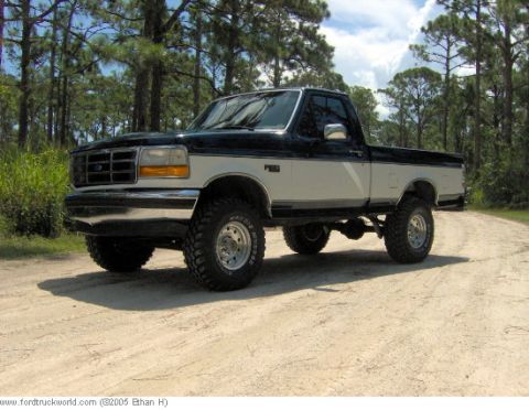 1995 Ford F-150 - This lifted 1995 Ford F-150 is shown from a 3/4 front angle on a dirt road.