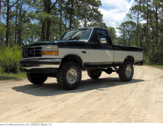 1995 Ford F-150 pickup truck with a lift kit parked on a dirt road