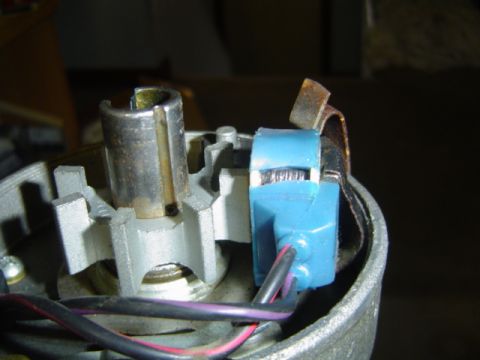 1979 Ford Bronco - Close-up inside a disassembled steering column housing, showing the cast aluminum lock plate area, a worn ignition lock cylinder sleeve, an…