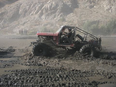 1987 Ford Bronco - This modified 1987 Ford Bronco navigates a muddy terrain, its off-road capabilities.