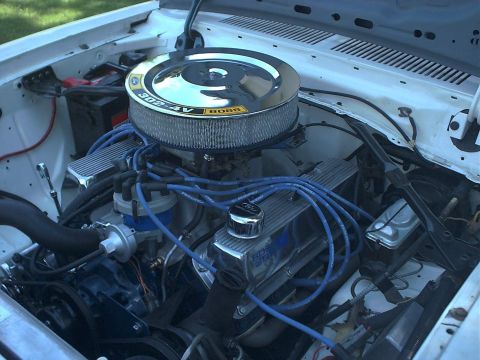 1978 Ford Mustang II - Close-up of an engine bay a chrome air cleaner and valve covers with visible engine details.
