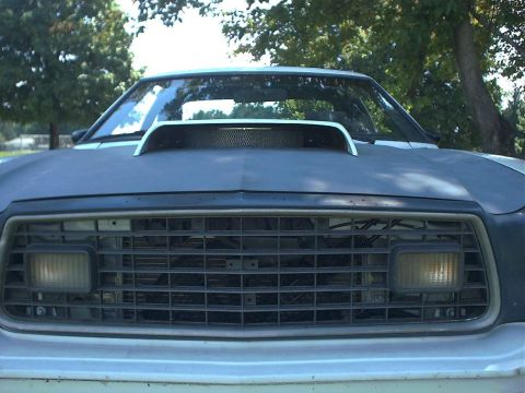 1978 Ford Mustang II - Front view of a 1978 Ford Mustang II, showing its grille and hood scoop.