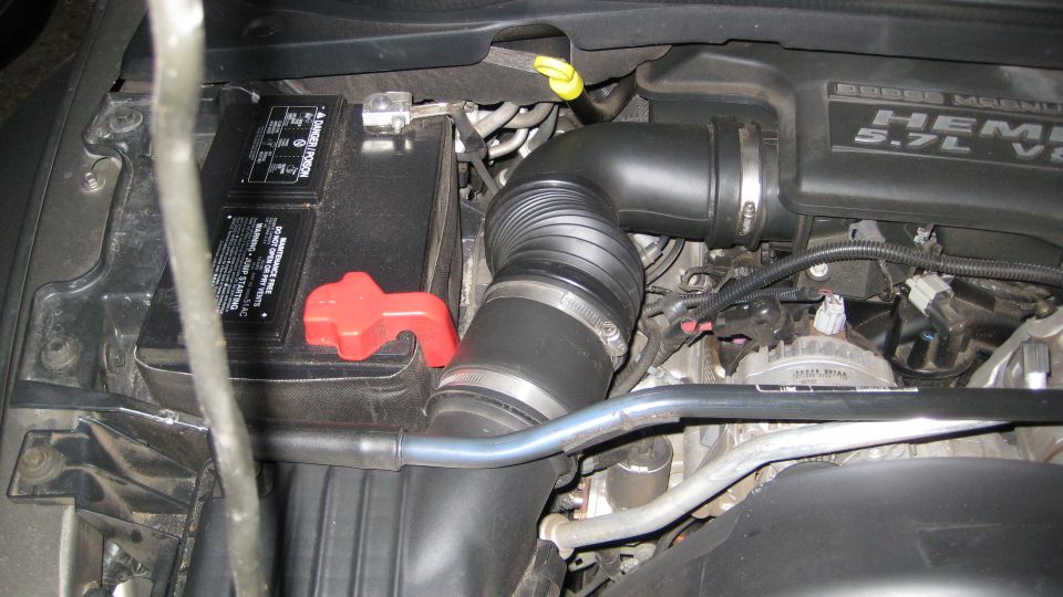 Dodge Hemi 5.7L V8 engine bay with battery and air intake tube