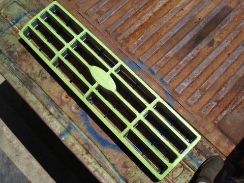 1984 Ford Bronco - A green grille with an oval emblem is shown, possibly for a vehicle part.