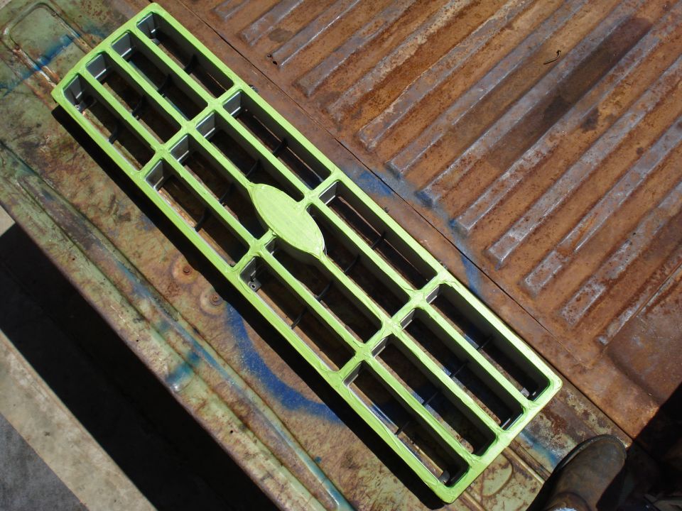 Green grille with oval emblem